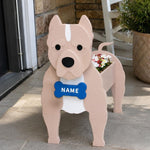 American Staffordshire Terrier dog planter filled with fresh flowers is placed in the garden