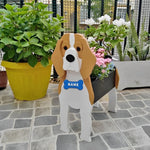 Beagle dog planter filled with fresh flowers is placed in the garden