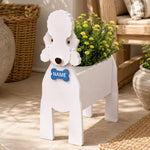 Bedlington Terrier dog planter with a name tag and flowers on a patio