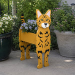 Bengal cat planter filled with fresh flowers is placed in the garden