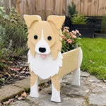 Border Collie dog planter filled with fresh flowers is placed in the garden