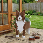 Border Collie dog planter filled with fresh flowers is placed in the garden