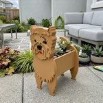 Cairn Terrier dog planter filled with fresh flowers is placed in the garden