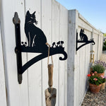 Cat silhouette metal hanging basket bracket mounted on outdoor wall for plant decoration