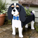 Cavalier King Charles Spaniel dog planter filled with fresh flowers is placed in the garden