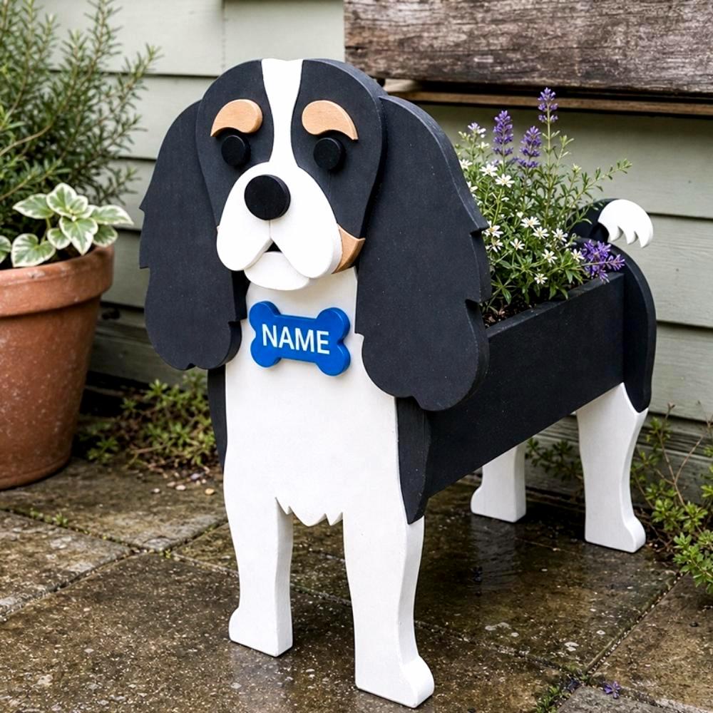 Cavalier King Charles Spaniel dog planter filled with fresh flowers is placed in the garden