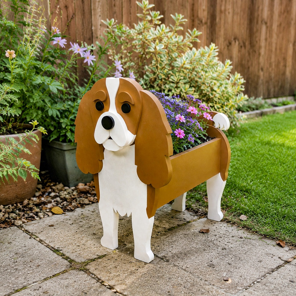 Cavalier King Charles Spaniel dog planter filled with fresh flowers is placed in the garden