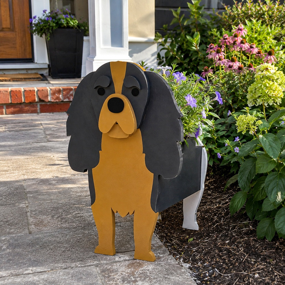 Cavalier King Charles Spaniel dog planter filled with fresh flowers is placed in the garden