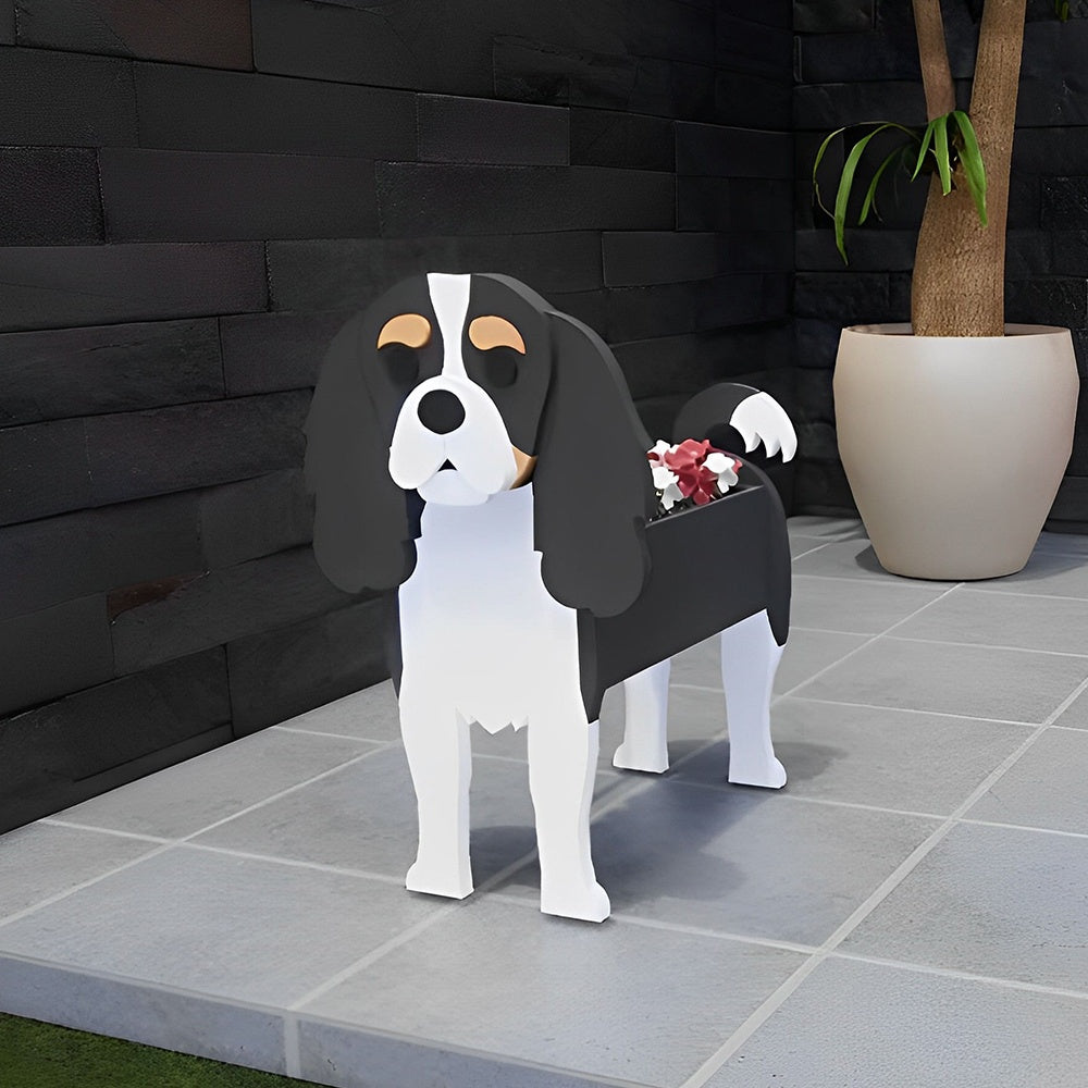 Cavalier King Charles Spaniel dog planter filled with fresh flowers is placed in the garden