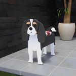 Cavalier King Charles Spaniel dog planter filled with fresh flowers is placed in the garden