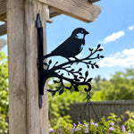 Chickadee bird on branch metal hanging basket bracket mounted on outdoor wall for plant decoration