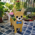Chihuahua dog planter filled with fresh flowers is placed in the garden