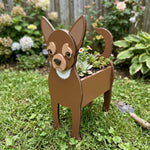 Chihuahua dog planter filled with fresh flowers is placed in the garden
