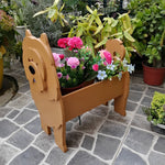 Chow Chow dog planter filled with fresh flowers is placed in the garden