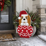 Christmas Beagle dog planter filled with fresh flowers is placed in the garden