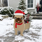 Christmas Pug dog planter filled with fresh flowers is placed in the garden