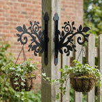 Classic scrollwork vines and leaves metal hanging basket bracket mounted on outdoor wall for plant decoration