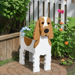 Cocker Spaniel dog planter filled with fresh flowers is placed in the garden