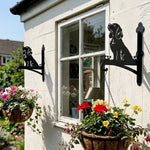 Cocker spaniel metal hanging basket bracket mounted on outdoor wall for plant decoration