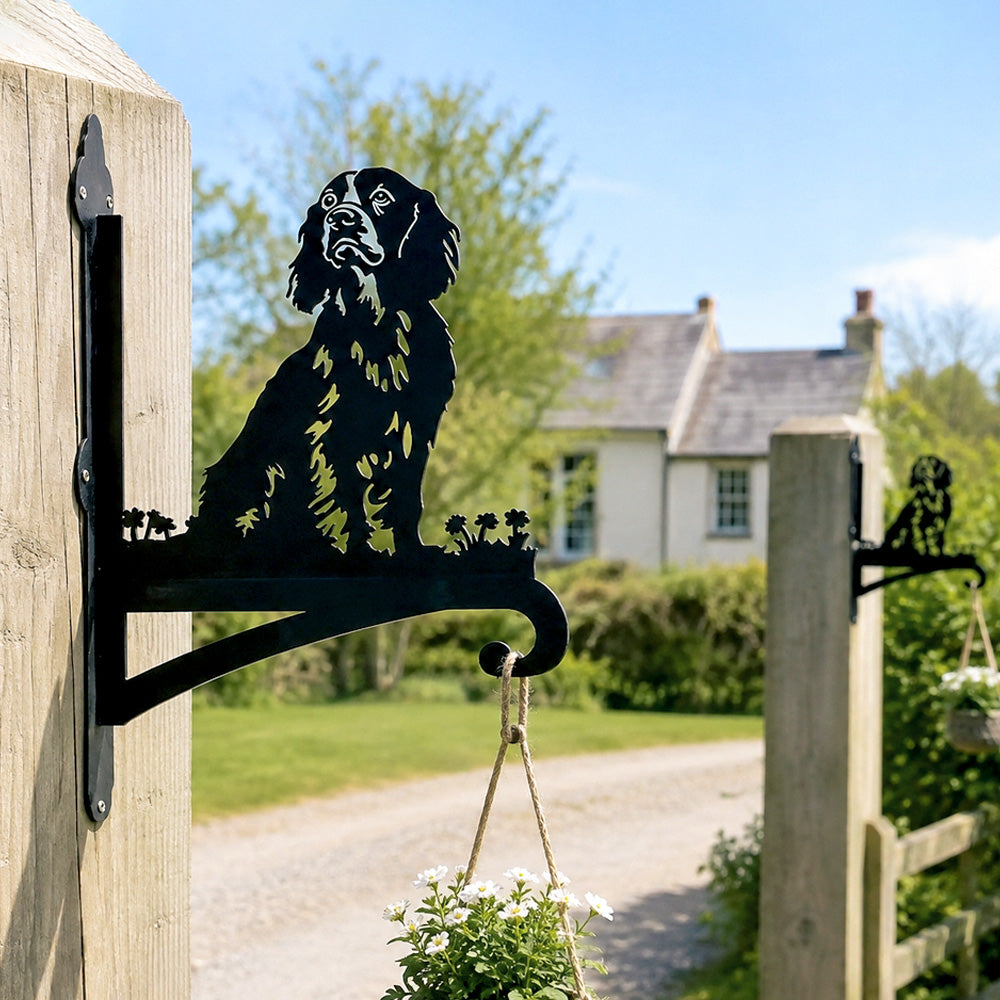 Cocker spaniel metal hanging basket bracket mounted on outdoor wall for plant decoration