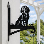 Cocker spaniel metal hanging basket bracket mounted on outdoor wall for plant decoration