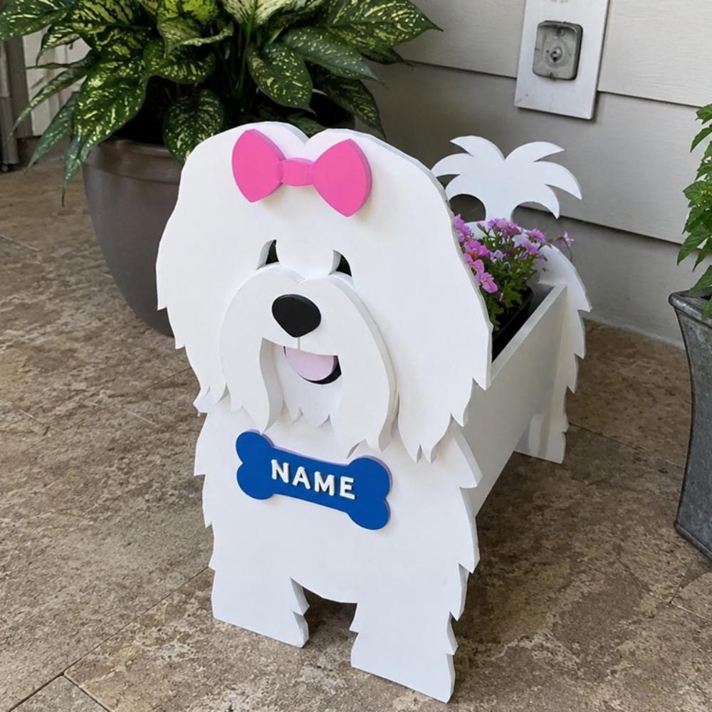 Coton de Tulear dog planter filled with fresh flowers is placed in the garden