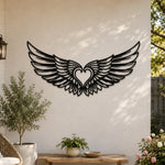 Black metal Cupid Heart wings wall art with intricate cutout details displayed on the wall
