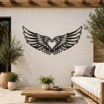 Black metal Cupid Heart wings wall art with intricate cutout details displayed on the wall