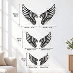Black metal Cupid Heart wings wall art with intricate cutout details displayed on the wall