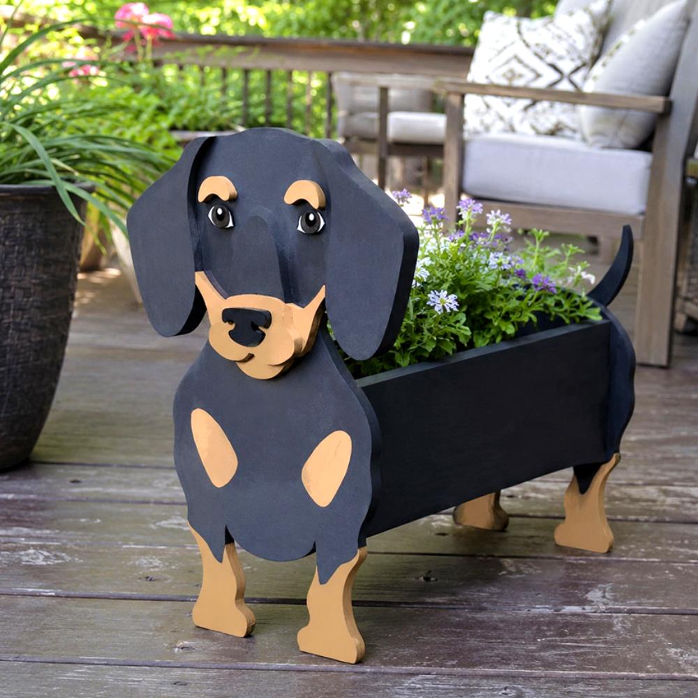 Dachshund dog planter filled with fresh flowers is placed in the garden