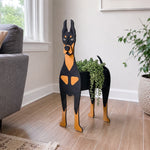 Doberman dog planter filled with fresh flowers is placed in the room