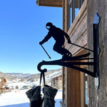 Downhill skier metal hanging basket bracket mounted on outdoor wall for plant decoration