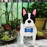 French Bulldog planter filled with fresh flowers is placed in the garden