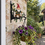 Garden gnome metal hanging basket bracket mounted on outdoor wall for plant decoration