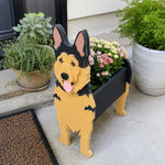 German Shepherd dog planter filled with fresh flowers is placed in the garden