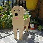 Golden Retriever dog planter filled with fresh flowers is placed in the garden
