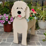 Goldendoodle dog planter filled with fresh flowers is placed in the garden