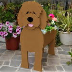 Goldendoodle dog planter filled with fresh flowers is placed in the garden