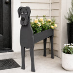 Great Dane dog planter filled with fresh flowers is placed in the garden