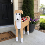 Greyhound dog planter filled with fresh flowers is placed in the garden