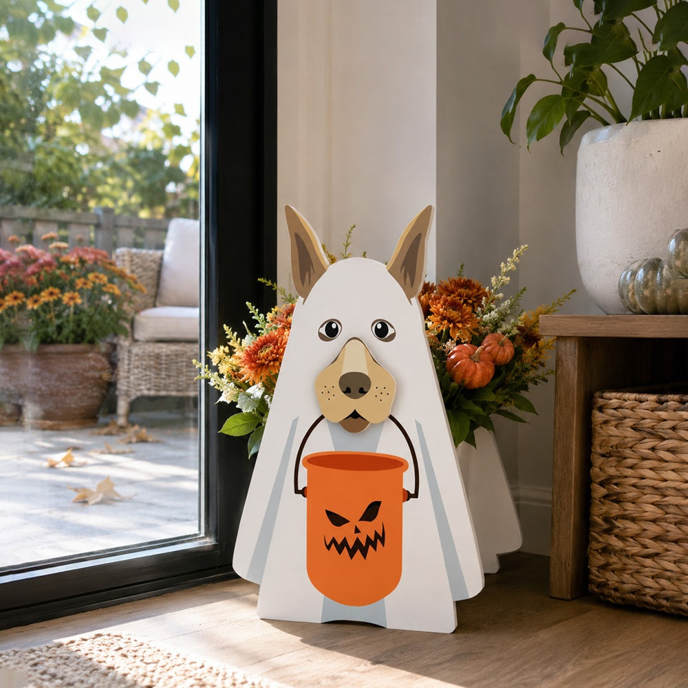 Halloween Ghost Dog Planter filled with fresh flowers is placed in the garden
