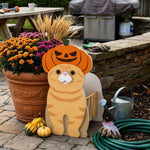 Halloween Orange Cat Planter filled with fresh flowers is placed in the garden