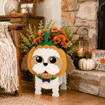 Halloween Shih Tzu Dog Planter filled with fresh flowers is placed in the garden
