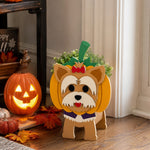 Halloween Yorkshire Terrier Dog Planter filled with fresh flowers is placed in the garden