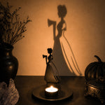 Haunted girl halloween metal candle holder casting a spooky shadow on the wall