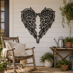 Black metal Heart Angel wings wall art with intricate cutout details displayed on the wall