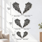 Black metal Heart Angel wings wall art with intricate cutout details displayed on the wall