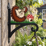 Hedgehogs with mushroom metal hanging basket bracket mounted on outdoor wall for plant decoration