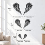 Black metal Layered Angel Wings wall art with intricate cutout details displayed on the wall