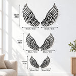 Black metal angel feather wings wall art with intricate cutout details displayed on the wall